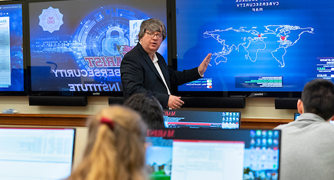 Image of a computer science faculty member teaching class.